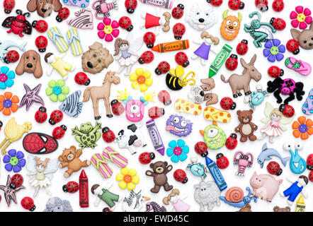 Childrens buttons, badges and plastic toys pattern on white background Stock Photo