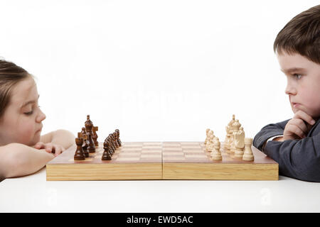 two children playing chess together Stock Photo