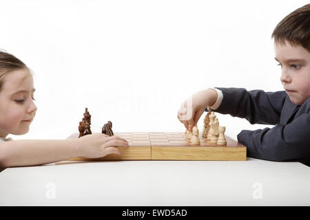 two children playing chess together Stock Photo