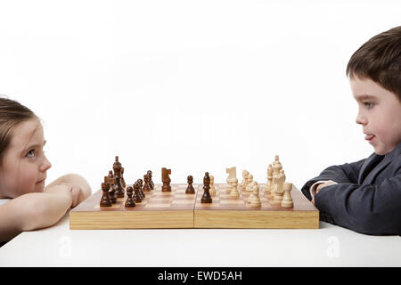 two children playing chess together Stock Photo