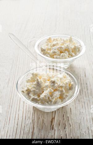 Fresh cottage cheese in a bowl on a wooden background Stock Photo