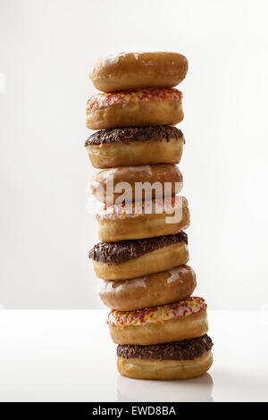 large stack of donuts on white background Stock Photo - Alamy
