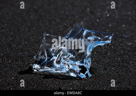 clear blue ice washing up on the black sand beach at Jokulsarlon Iceland Stock Photo