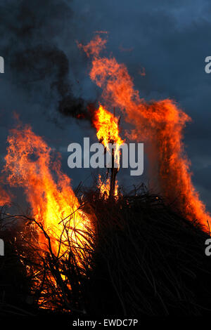 Nivaa Harbour, north of Copenhagen, Denmark. June 23, 2015. The rag witch burns at the stake on the traditional bonfire on the beach at the Sound in the Danish celebration of St. John's Eve, or Midsummer Eve. The bonfire events including a cultural speech by a well-known person and the singing of the traditional midsummer song are held by most local authorities throughout the country. But local bonfires and celebrating parties are arranged nearly everywhere. Credit:  Niels Quist/Alamy Live News Stock Photo