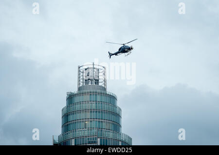 London, UK.  22 June, 2015. A helicopter flies over the MI6 building during filming of the new James Bond movie Spectre. Credit:  Pete Maclaine/Alamy Live News Stock Photo