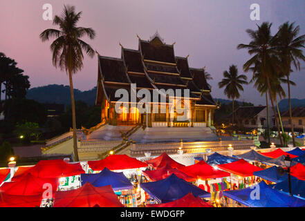 The HAW PHA BANG or Royal Temple sits above the famous NIGHT MARKET - LUANG PROBANG, LAOS Stock Photo