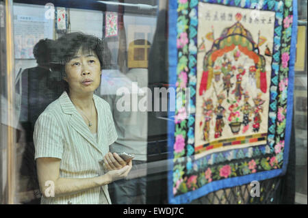 Changchun, China's Jilin Province. 24th June, 2015. A visitor looks at artworks of Man ethnic group during an Man embroidery exhibition in Changchun, capital of northeast China's Jilin Province, June 24, 2015. Credit:  Zhang Nan/Xinhua/Alamy Live News Stock Photo