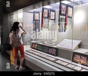 Changchun, China's Jilin Province. 24th June, 2015. Visitors look at artworks of Man ethnic group during an Man embroidery exhibition in Changchun, capital of northeast China's Jilin Province, June 24, 2015. Credit:  Zhang Nan/Xinhua/Alamy Live News Stock Photo