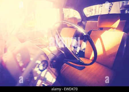 Vintage filtered old car interior against sun. Stock Photo