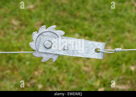 Ratchet fence tensioner for tightening wire stock fences on farms Stock Photo