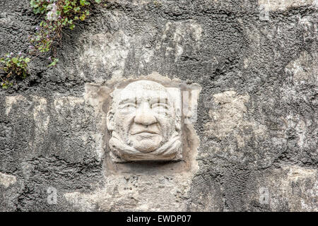 Hand carved Bath stone face on a wall in Walcot Street Bath one of more than 30 grotesques on display Stock Photo