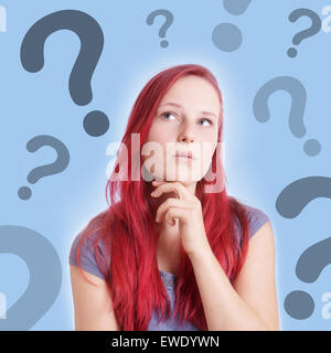 pensive young woman with interrogation marks Stock Photo