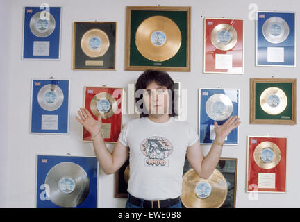 MUD  UK glam rock group with bass player Ray Stiles showing some of the groups awards about 1974 Stock Photo