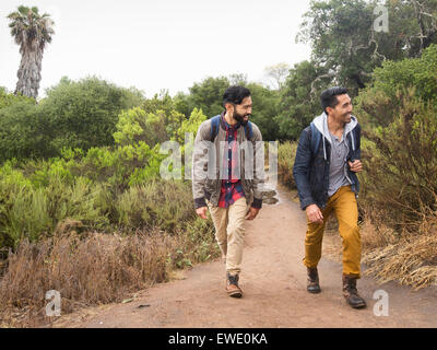 Two young men walking in a park Stock Photo