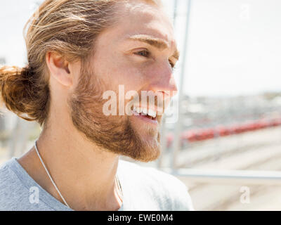 A young man with beard, red hair and ponytail Stock Photo