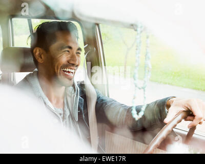 Young man in a car behind the steering wheel, driving Stock Photo