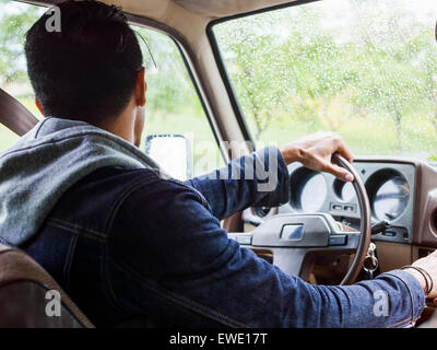 Young man in a car behind the steering wheel, driving Stock Photo