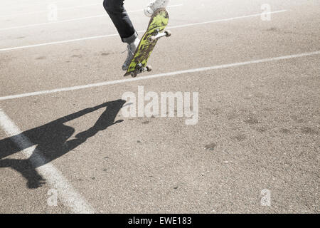 Young man skateboarding in a car park urban city life Stock Photo