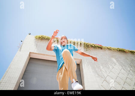 Young man jumping in the air on street parcour parkour Stock Photo