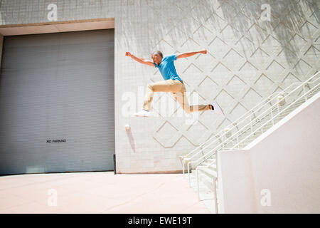 Young man jumping down stairs parcour parkour Stock Photo