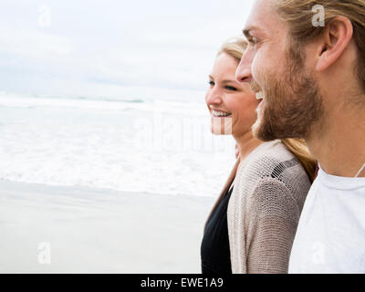 Close up of a smiling young man and young woman on a beach Stock Photo