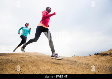 Two women jogging along the coast fitness Stock Photo
