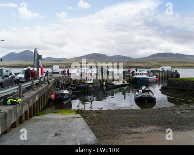 Port Askaig harbour Isle of Islay Argyll and Bute Scotland second main ferry port Islay with view towards Jura on lovely May day weather blue sky Stock Photo