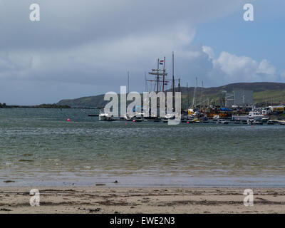 View across Leomadais Bay to Port Ellen harbour Isle of Islay Argyll and Bute Scotland long sandy beach sheltered bay lovely May day weather blue sky Stock Photo