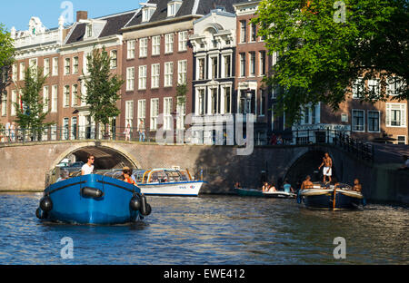 Amsterdam, tourists enjoiing a boat trip in the canals of the old city center Stock Photo