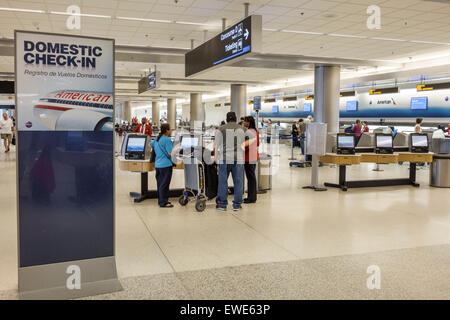 Miami Florida,International Airport,MIA,interior inside,terminal,gate,self service kiosk,monitor,screen,touch,check in,checking,domestic,American Airl Stock Photo