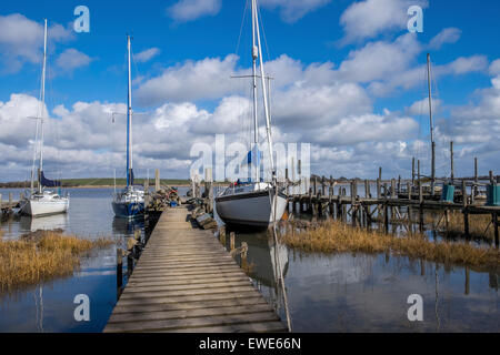 Two yachts moored along the jetties no sails, cloudy sky, sea, Stock Photo