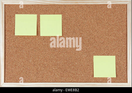 Three post-it notes sticked on corkboard. Stock Photo