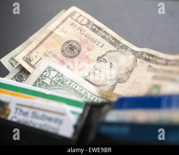 A US ten dollar bill with Alexander Hamilton is seen amongst other bills poking out of a wallet in New York on Thursday, June 18, 2015. The US Treasury Dept. announced that the 2020 redesign of the ten dollar bill will replace Alexander Hamilton with a woman. The change in the bill will occur on the 100th anniversary of the 19th Amendment giving women the right to vote. (© Richard B. Levine) Stock Photo