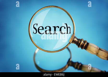 Magnifying glass focus on the word search Stock Photo