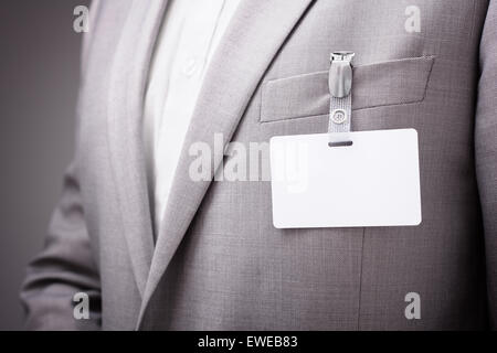 Businessman wearing blank name tag Stock Photo