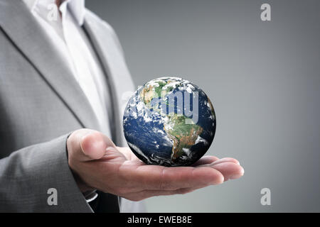 Businessman holding the world in his hands Stock Photo