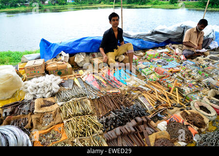 A shopkeeper waiting for customers to sale products at Kaikkarateke weekly market, Narayanganj district in Bangladesh. Stock Photo