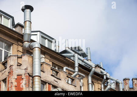 New attic windows in old living house roof with ventilation pipes, high-tech architecture Stock Photo