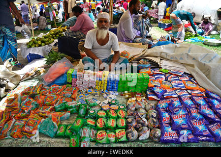 A shopkeeper waiting for customers to sale products at Kaikkarateke weekly market, Narayanganj district in Bangladesh. Stock Photo