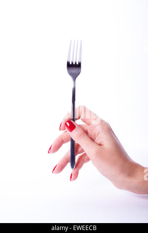 Woman hand with red manicure holding fork Stock Photo