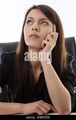 office worker sitting at her desk deep in thought Stock Photo