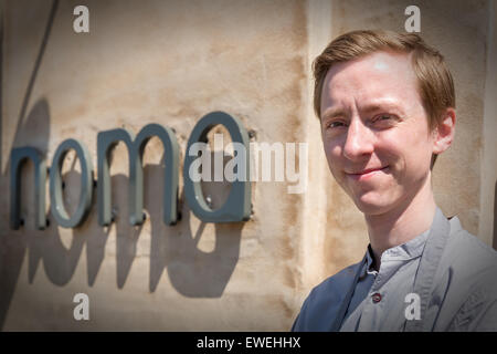 Portrait of a young student (chef) in front of the old Noma restaurant, Christianshavn, Copenhagen, Denmark Stock Photo