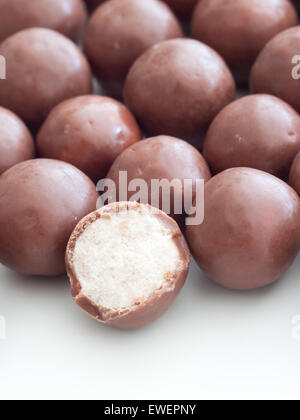 A close-up of Whoppers candy.  Whoppers are malted milk balls covered with chocolate and produced by The Hershey Company. Stock Photo