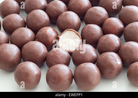 A close-up of Whoppers candy.  Whoppers are malted milk balls covered with chocolate and produced by The Hershey Company. Stock Photo