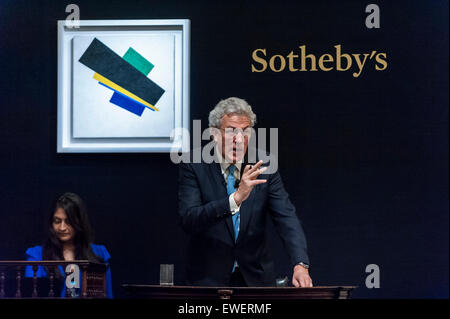London, UK. 24 June 2015. The auctioneer manages bidding for Kazmir Malevich's 'Suprematism, 18th construction' which sold for a hammer price of £19m.  Sotheby's Impressionist & Modern art evening sale realised a total of £178.6m, the second highest total for any sale ever held in London. Credit:  Stephen Chung / Alamy Live News Stock Photo