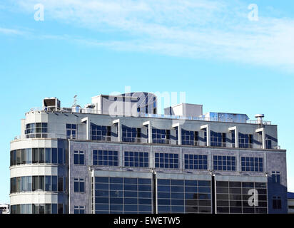 Ventilation pipes and actuators on the roof of an industrial building Stock Photo