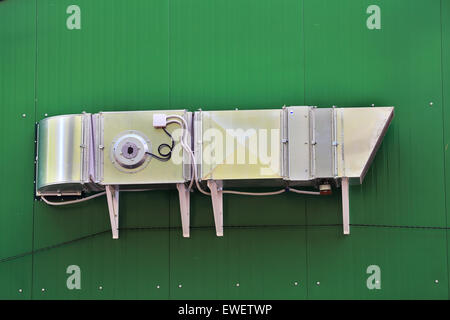 Ventilation pipes and actuators on the wall of an industrial building Stock Photo