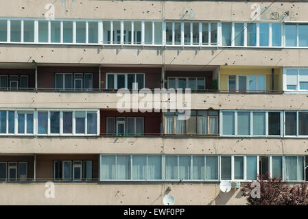 the facade of a building with signs of shots of gunfire on the walls in Sarajevo Stock Photo