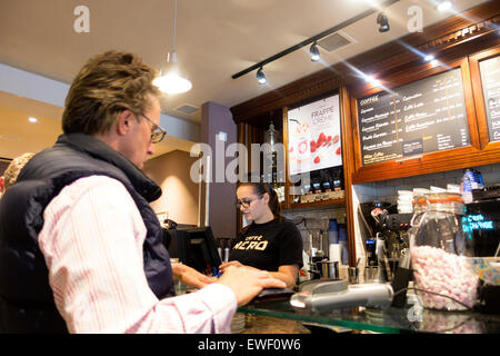 Caffe Nero customer; A customer being served at the bar by a barista, Caffe Nero, Newmarket Suffolk UK Stock Photo