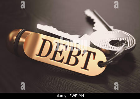 Debt written on Golden Keyring. Stock Photo